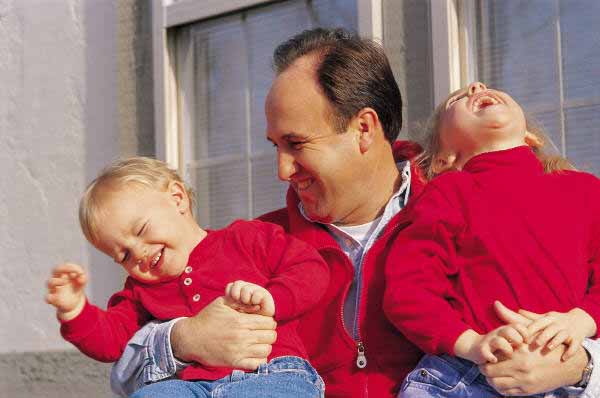 Father hugging kids