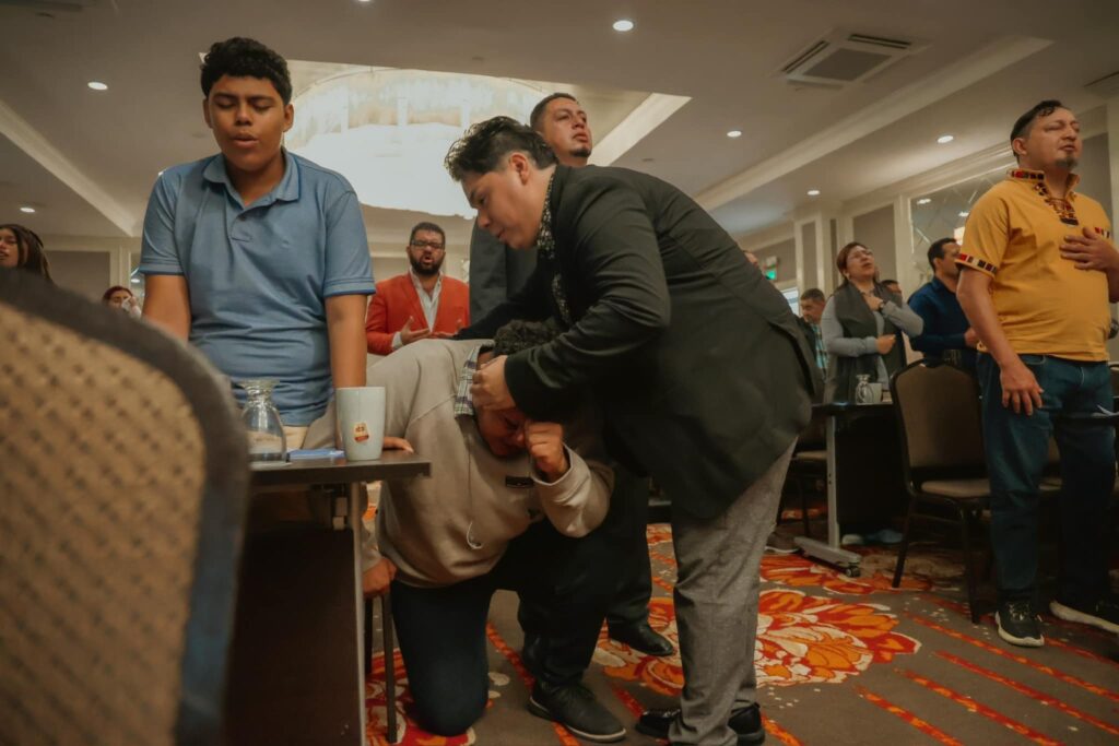 Powerful time of worship. Erickson praying for a young man who fell on his knees before the Lord.