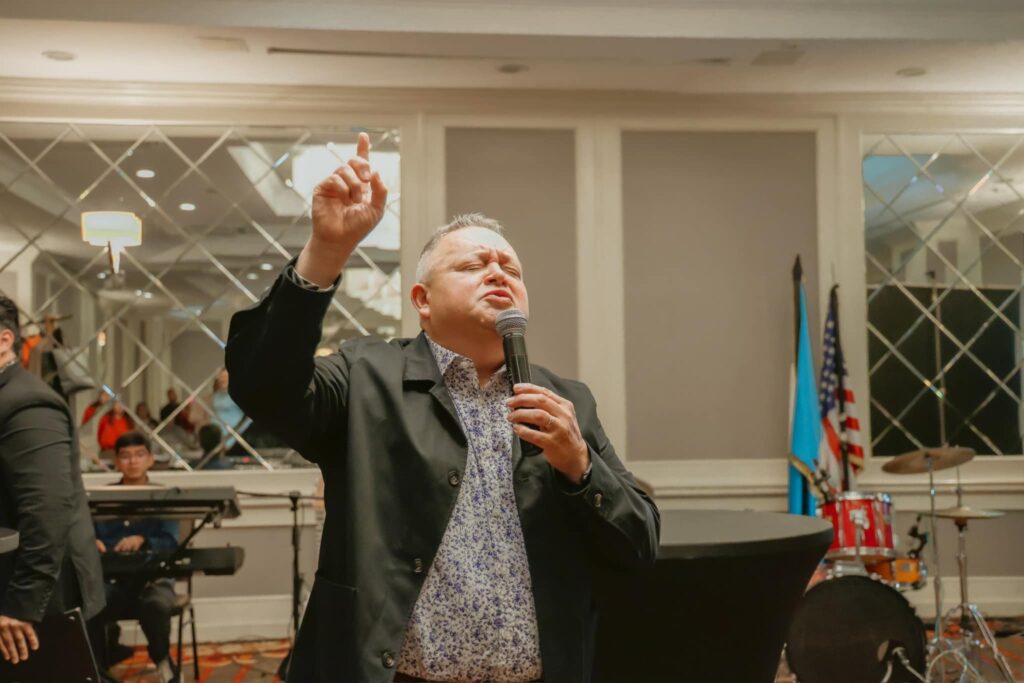 Apostle and Pastor Eddie Contreras leading prayer and ministry time, Day 2